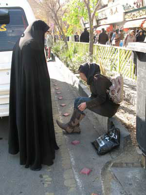 女性警察官（左）がバッドヘジャーブな女性（右：ズボンの裾をブーツの中に入れている点が問題になっている）に注意を与えている様子